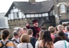 An image of a Tower of London Beefeater speaking to a crowd.