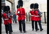 An image of a group of British Royal Guards walking through the Tower of London.