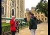 A man inside the Tower of London speaking with his guide from The Tour Guy.