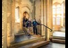 A group of tourists walking inside the Tower of London.