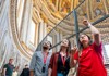A pair of tourists standing on the first level of St. Peter's Dome with their guide from The Tour Guy.