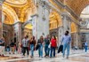 A group of tourists walking through St. Peter's Basilica with their guide from The Tour Guy.
