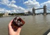 Man posing with donuts at Tower Bridge
