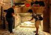 A tourist looking at a crypt with his guide from The Tour Guy.