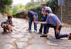 A group of tourists standing along the Appian Way (Via Appia) in Rome with a guide from The Tour Guy.