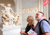 Tourists looking at Lacoon and His Sons inside the Vatican Museums.