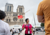 A tour guide outside of Notre Dame Cathedral.